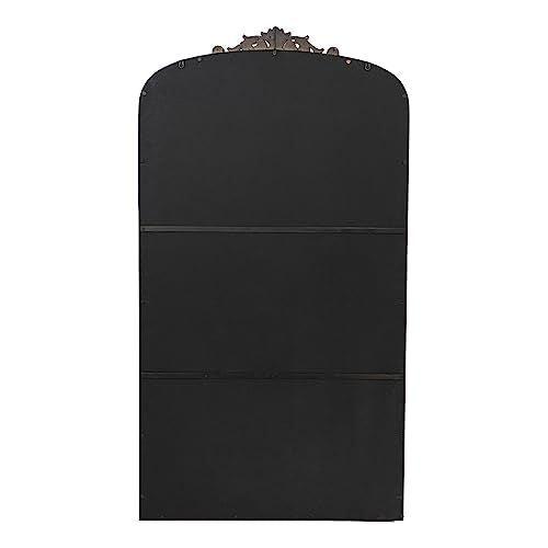Gold mirror hanging above console table in entryway