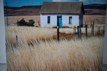 Vintage farmhouse canvas print with blue door and wooden fence
