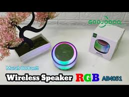 Compact waterproof speaker on outdoor setting