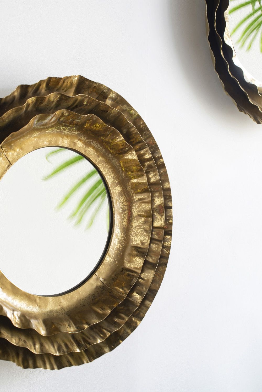 Mid-century modern round mirror gold frame on wall in living room