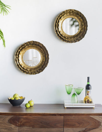 Gold round mirror on wall with decorative interior background
