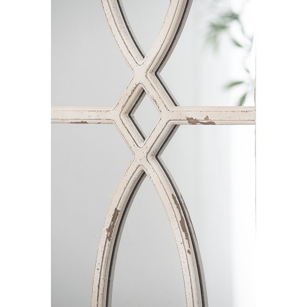 Set of two mirrors on a living room wall with decorative accents