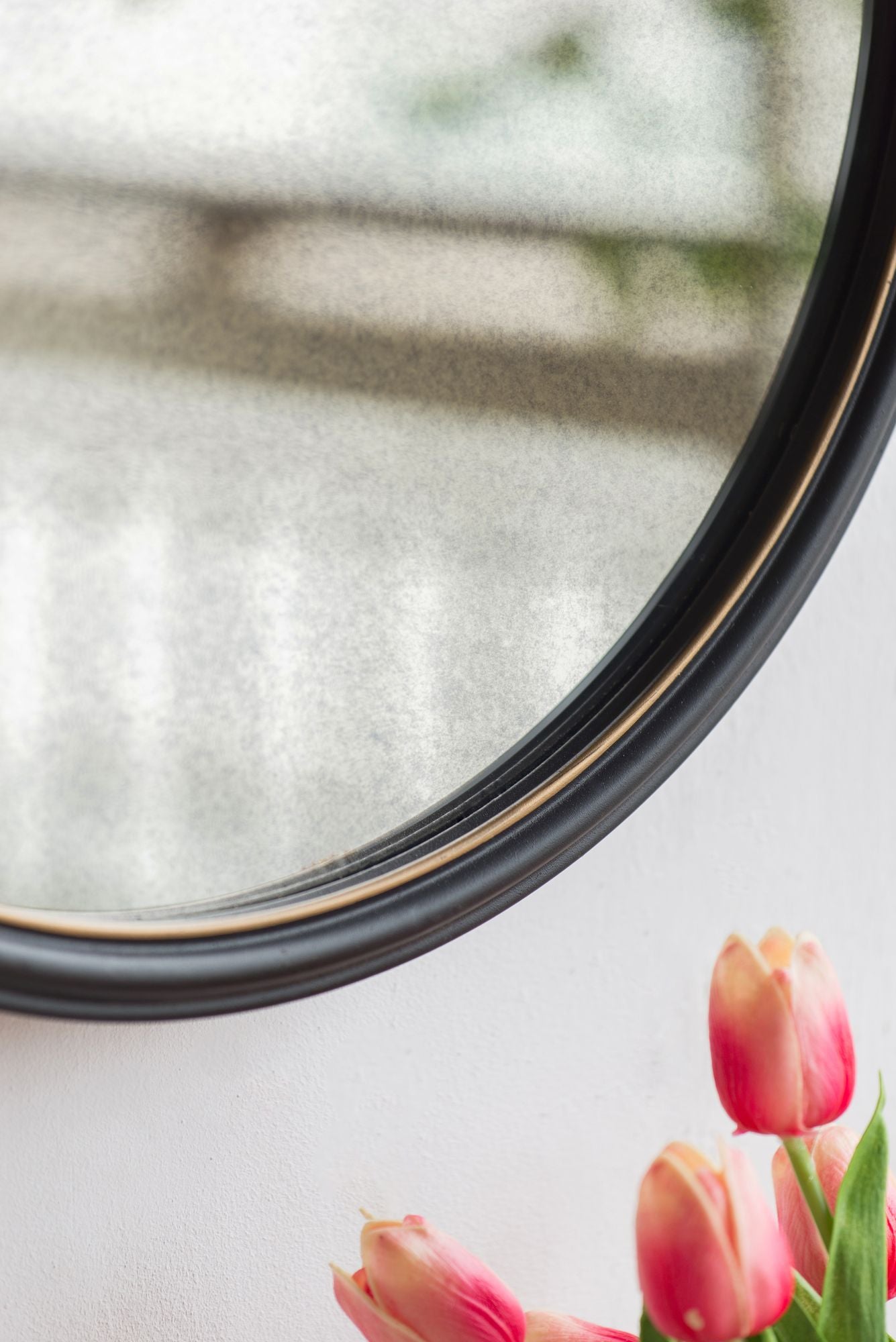 Cleveland mirror with rope strap hanging on peg