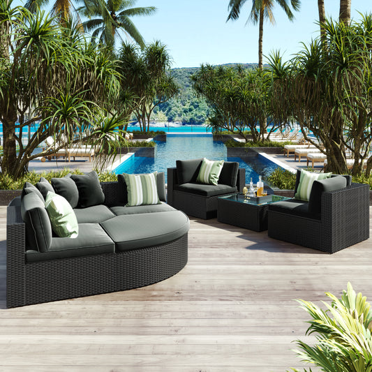 GO 7-piece outdoor wicker sofa set with gray cushions and striped green pillows on patio