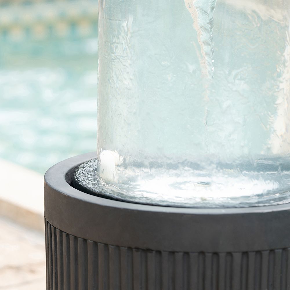 20x20x19.5 inch heavy cement round black ribbed outdoor water fountain with light - in garden setting