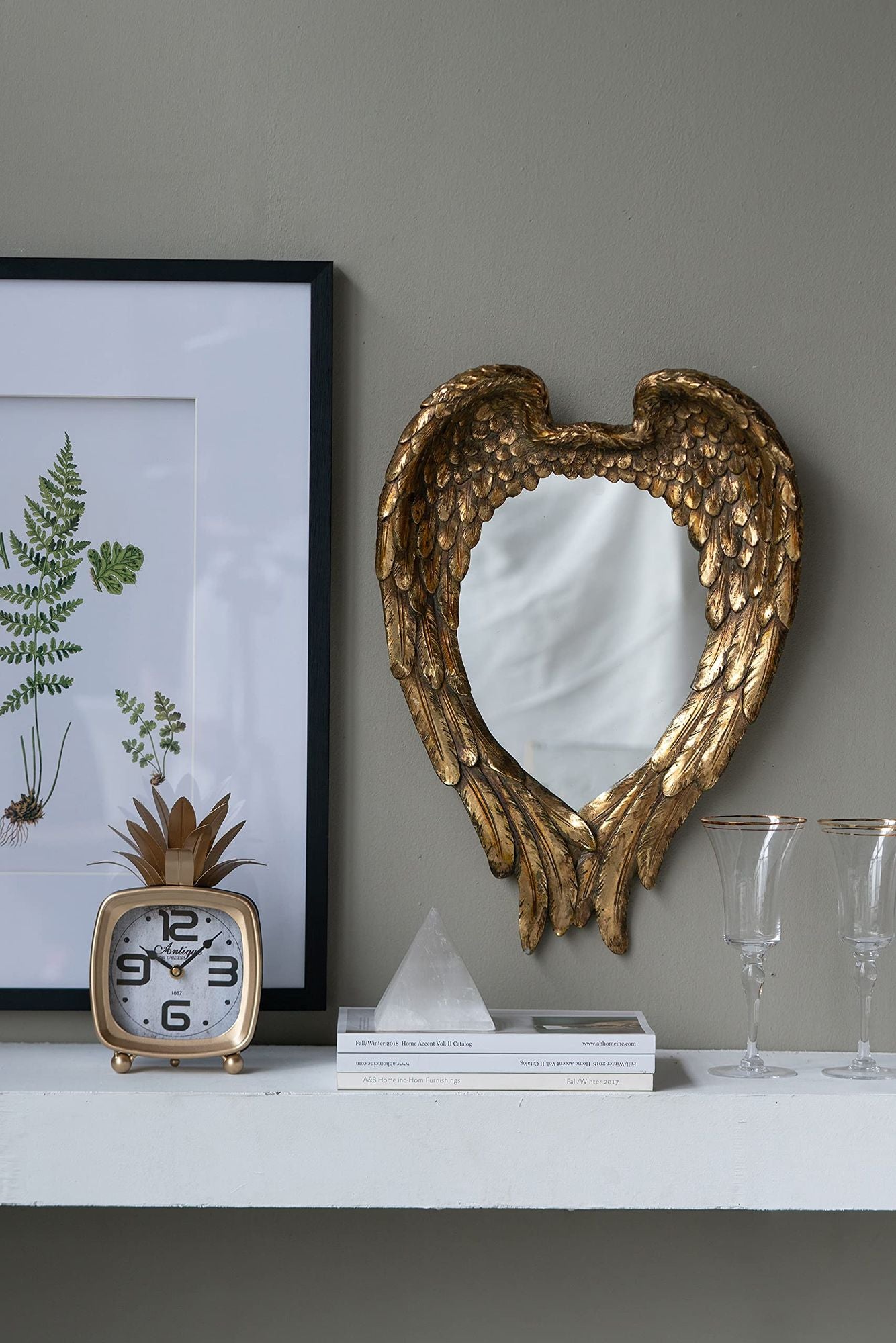 Golden wing mirror in entryway setting