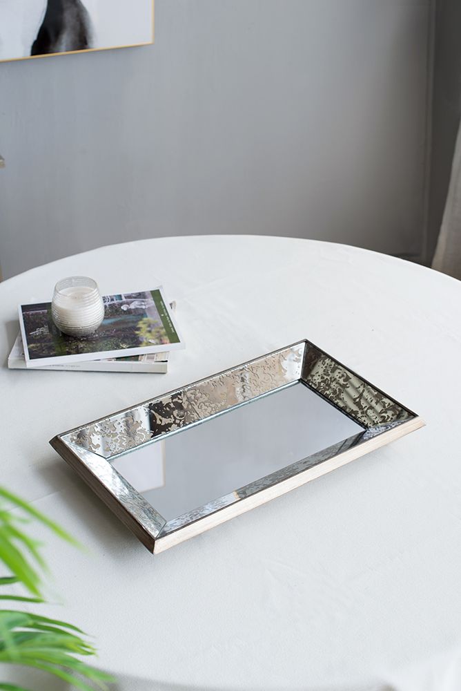 Close-up of antique silver mirror frame with floral details