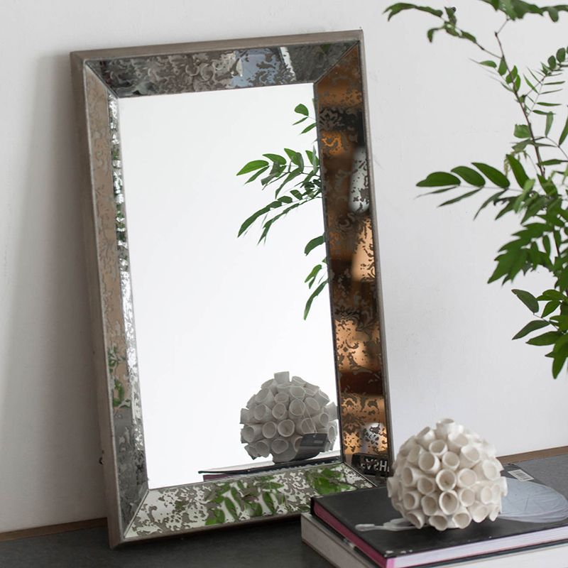 Mirror with floral accents in living room setting