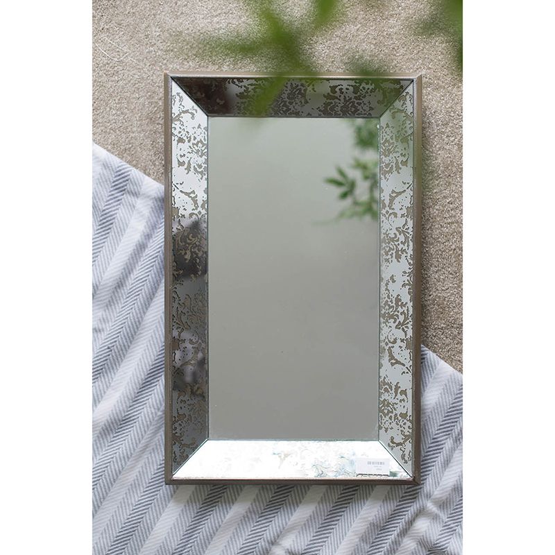 Antique silver rectangle mirror with floral accents on wall