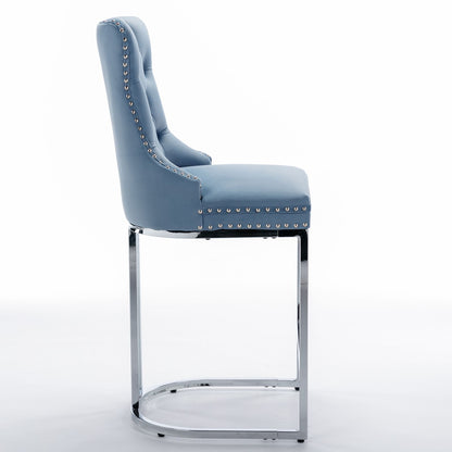 Set of 2 counter height bar stools light blue velvet with chrome base in kitchen setting