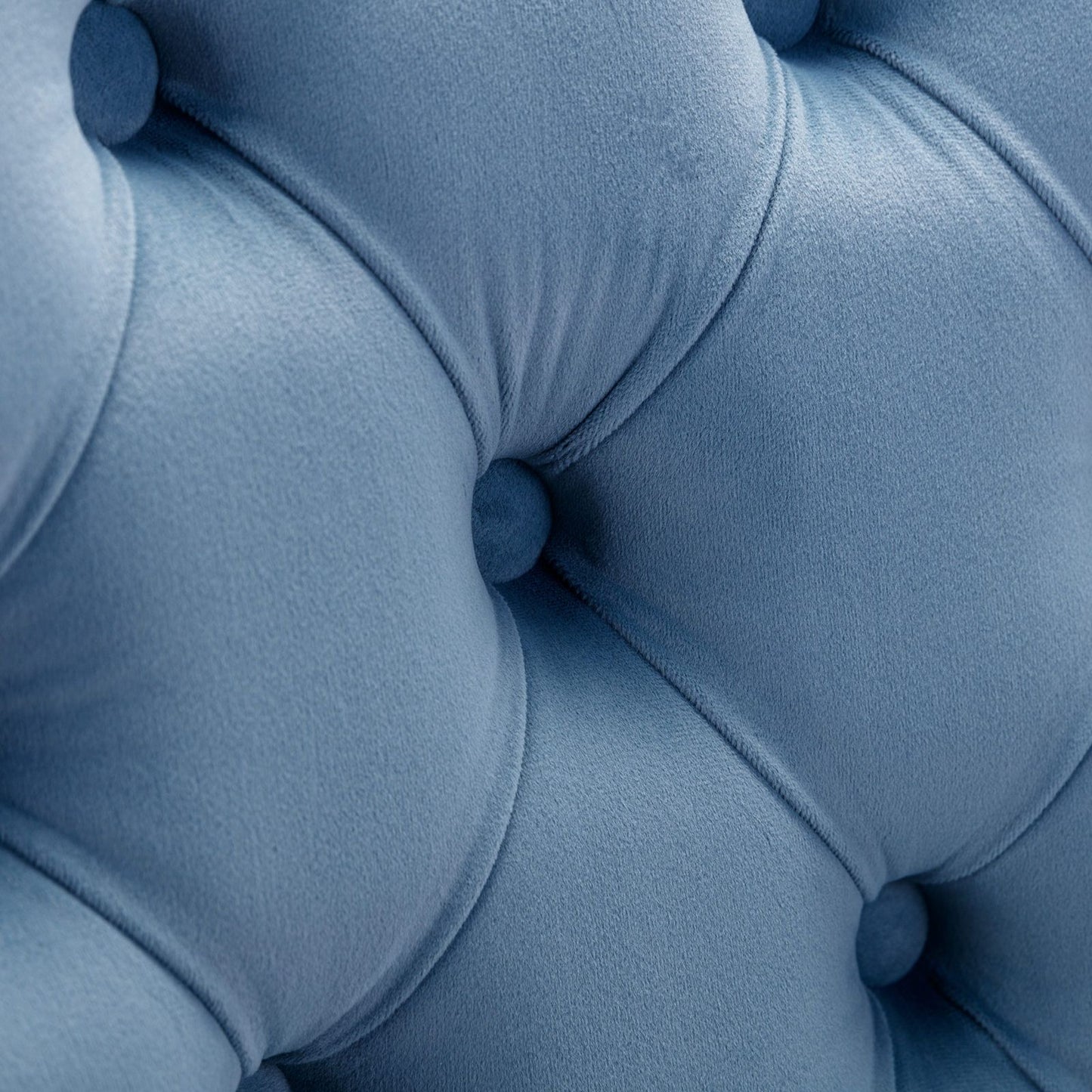 Light blue velvet bar stools with button tufted back and rivet trim detail