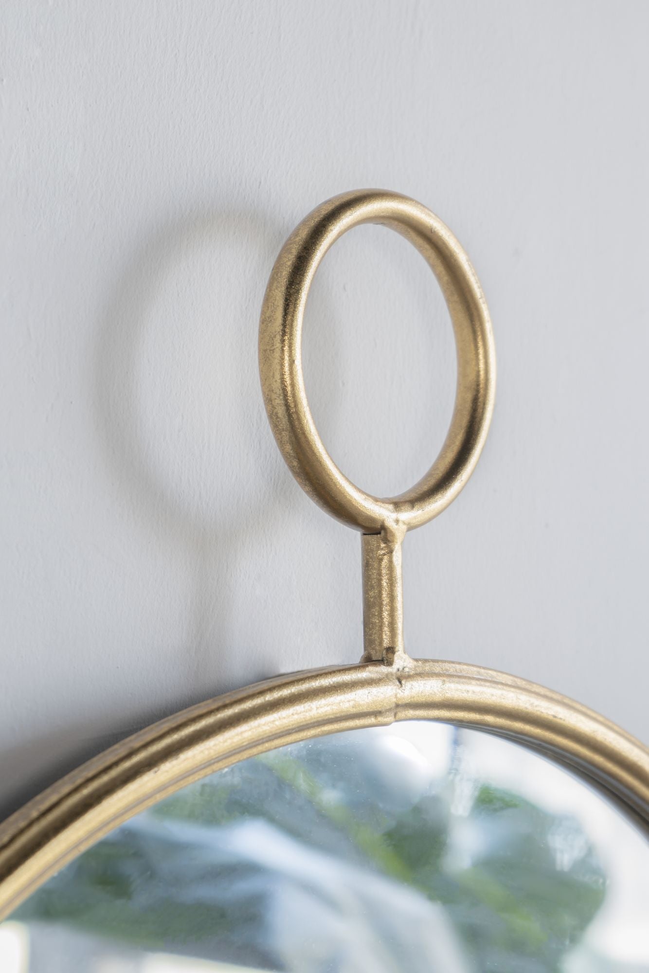 Mirror with gold metal frame in powder room
