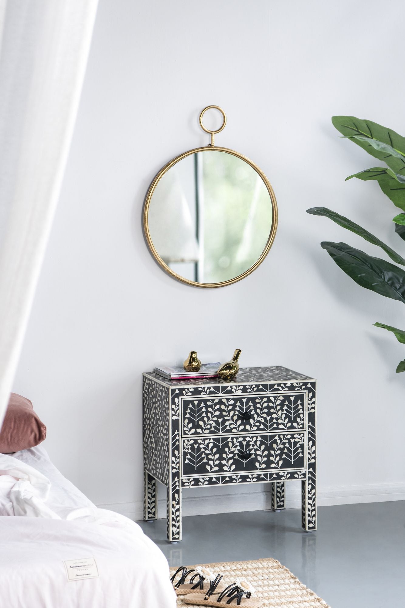 Gold frame accent mirror on wall in entryway