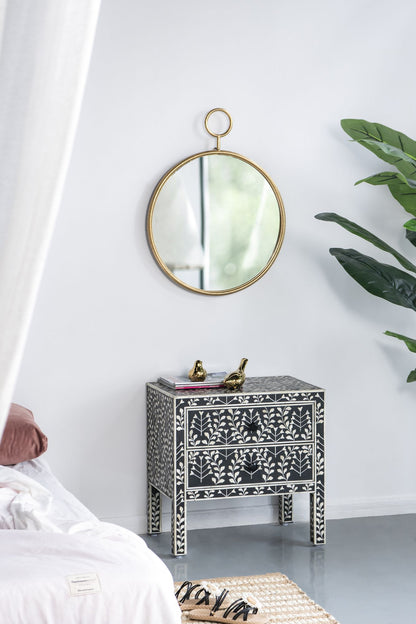Gold frame accent mirror on wall in entryway