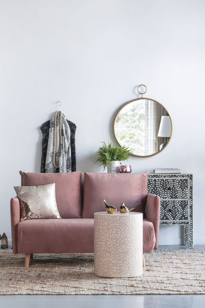 Close up of gold metal frame on round wall mirror
