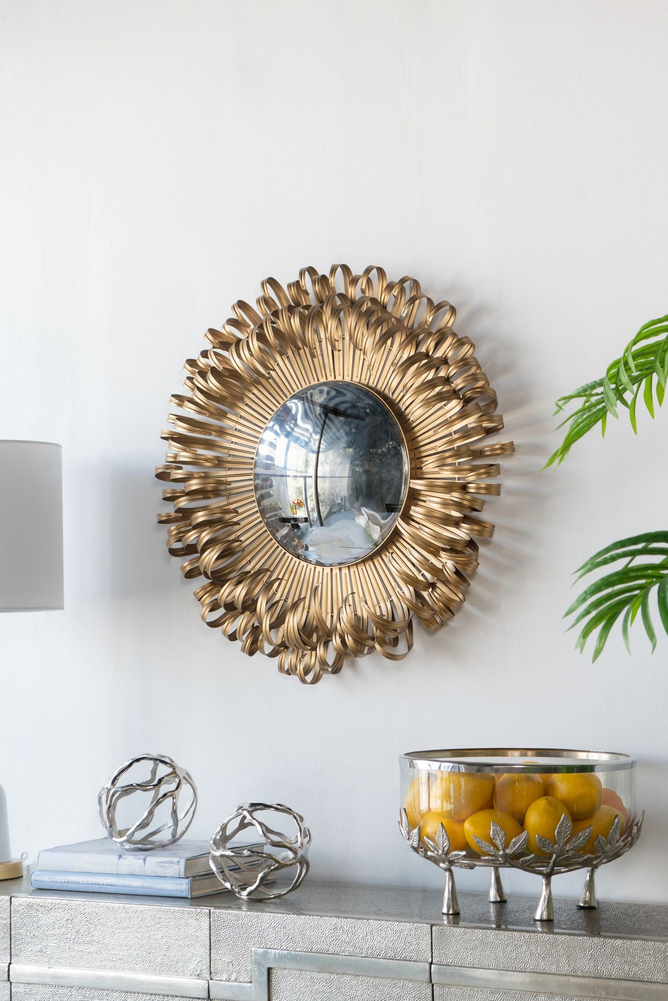 27 inch golden sunburst mirror in living room setting