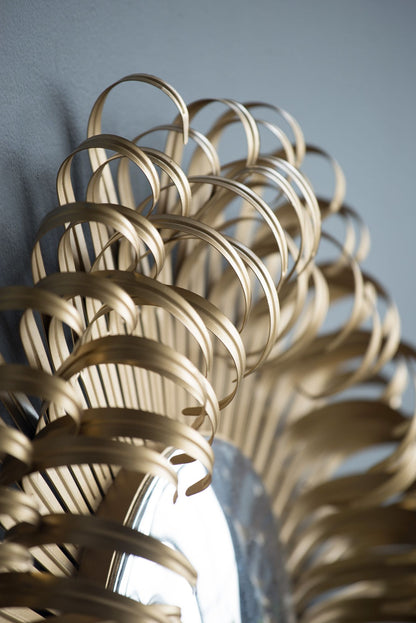 Sunburst wall mirror golden finish detail of spokes
