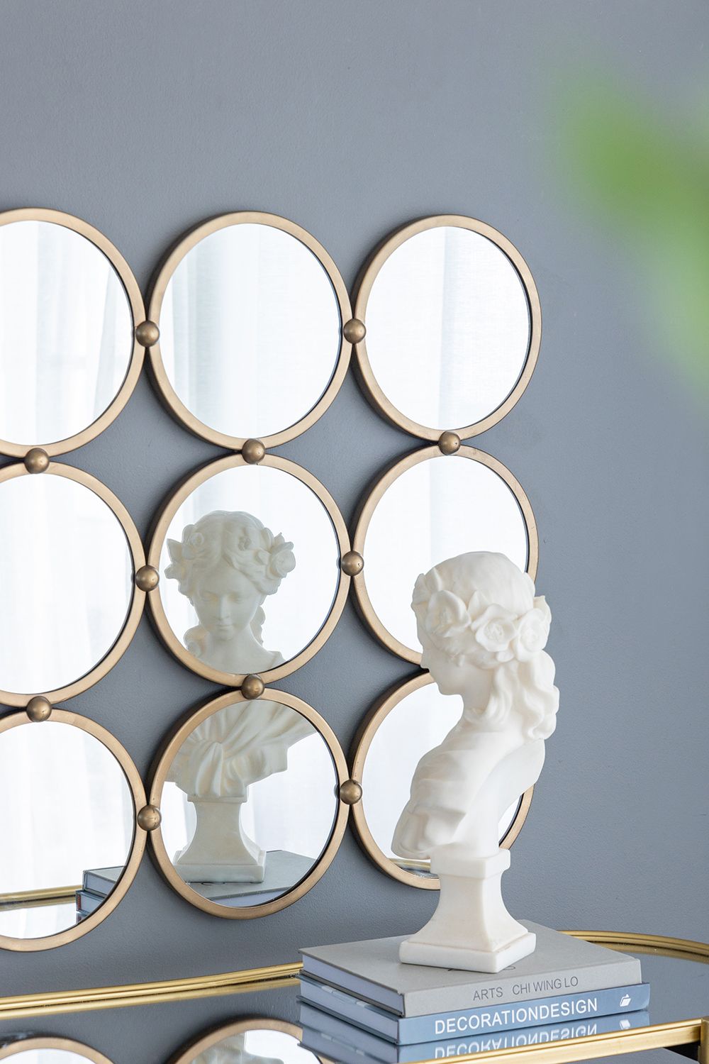 Harmony 9 ring metal wall mirror in bedroom setting