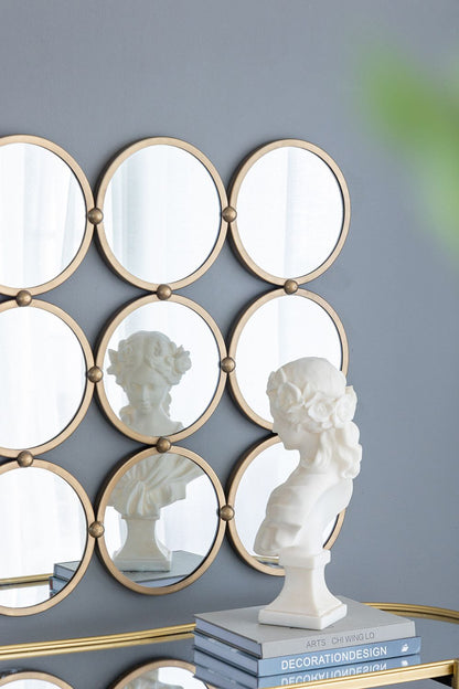 Harmony 9 ring metal wall mirror in bedroom setting