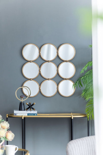 Close up of nine metal rings on contemporary decorative mirror