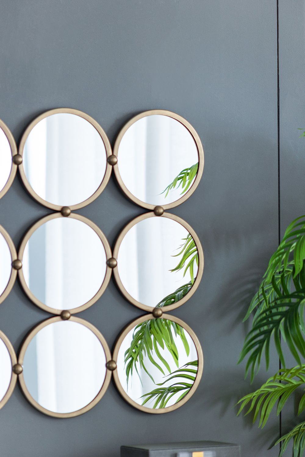 Minimalist wall mirror with metal rings in entryway decor