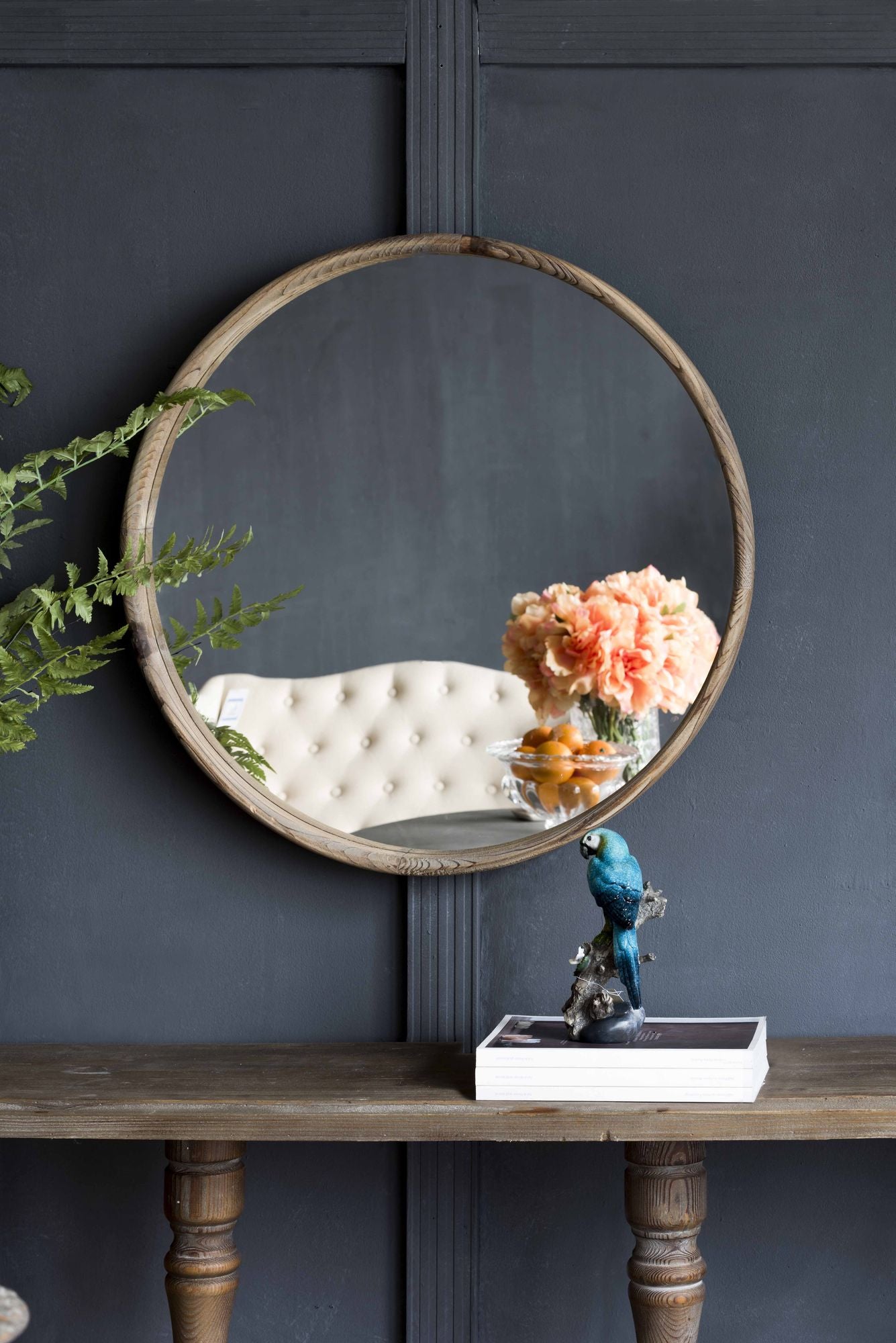 Round wood mirror as entryway accent