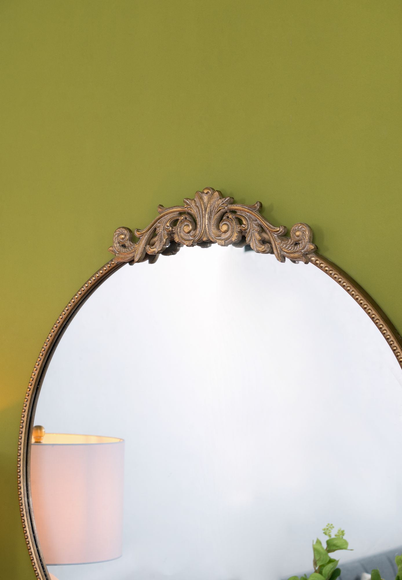 Vintage gold mirror wall mounted in living room setting