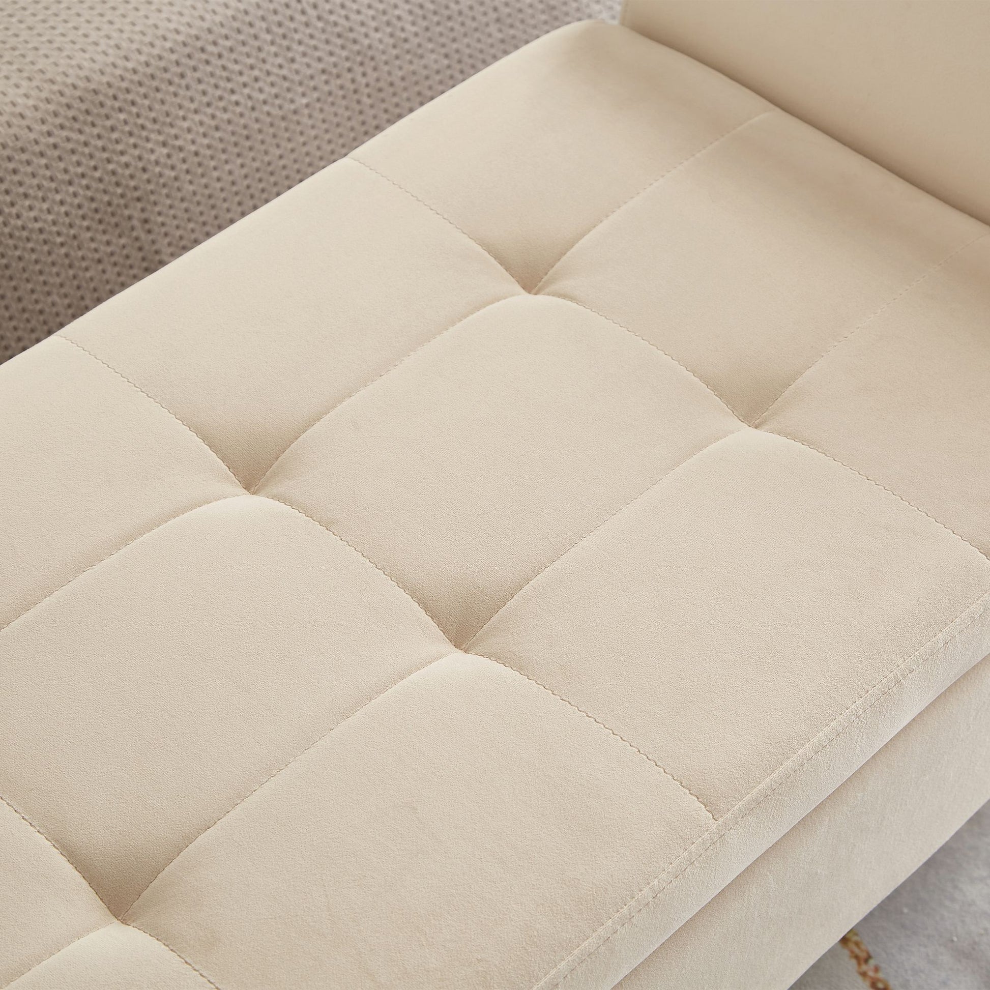 Beige velvet bench used as shoe storage in entryway