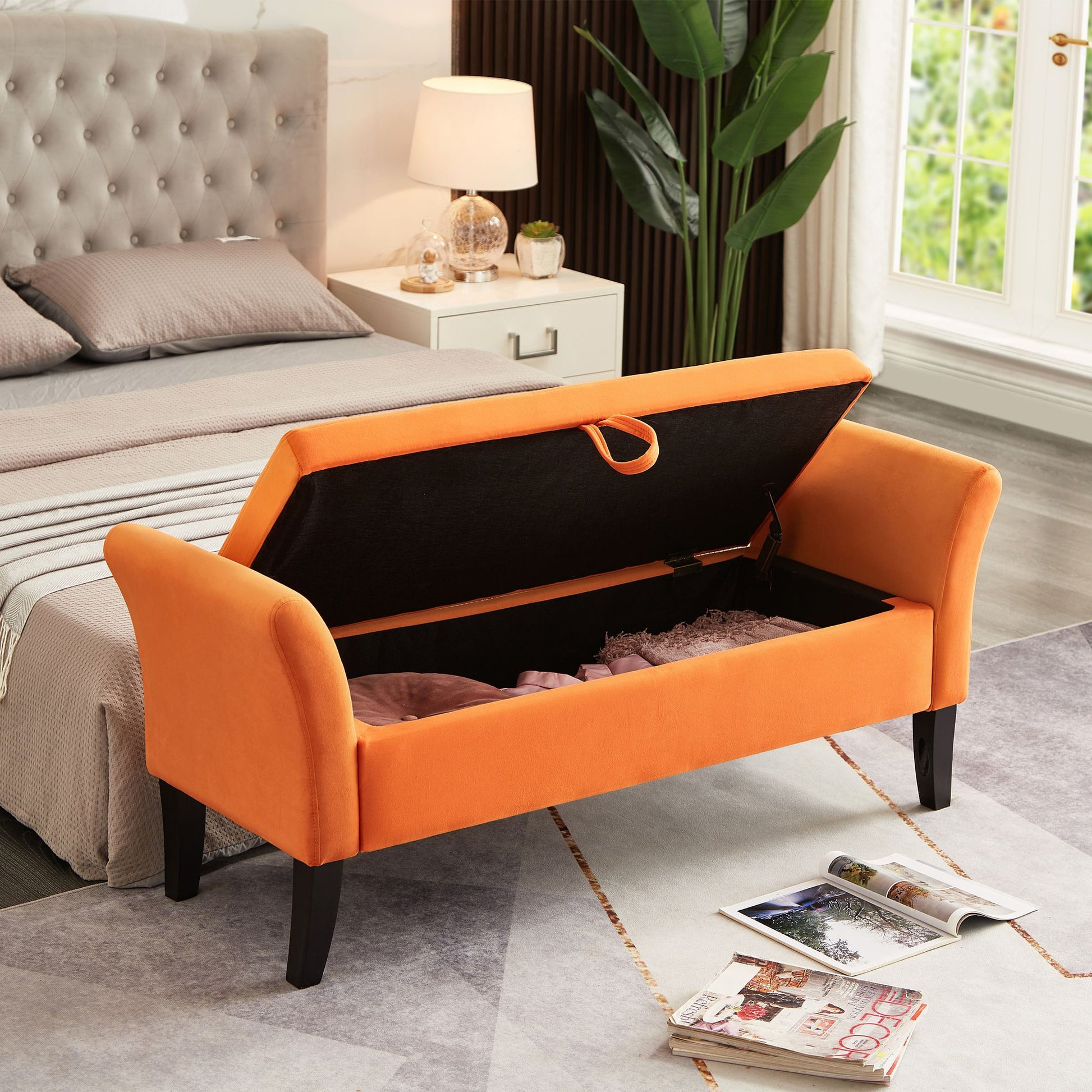 Orange velvet bed bench with storage compartment open showing interior