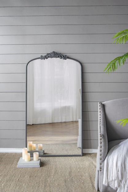 Arched mirror in entryway decor setting