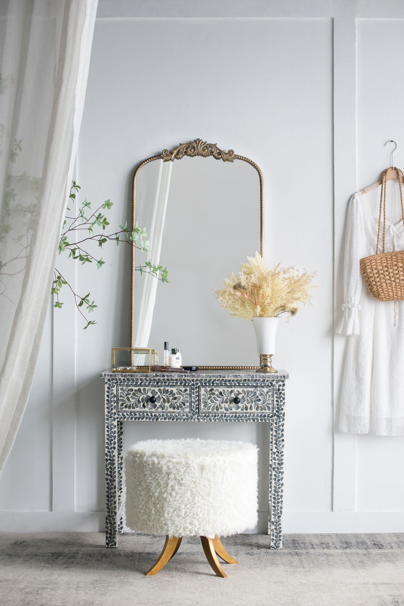 Arched gold mirror with ornate top detail close up