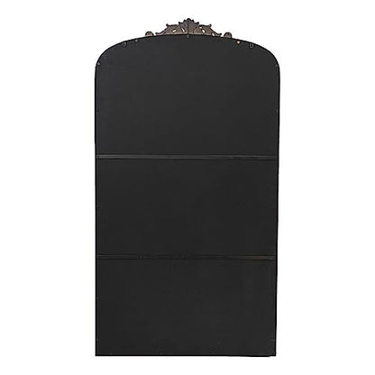 Gold mirror hanging above console table in entryway