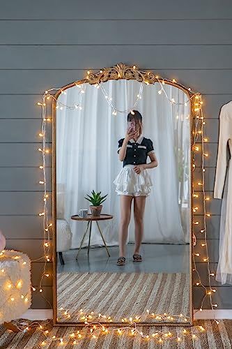 Full length gold mirror in living room decor setting