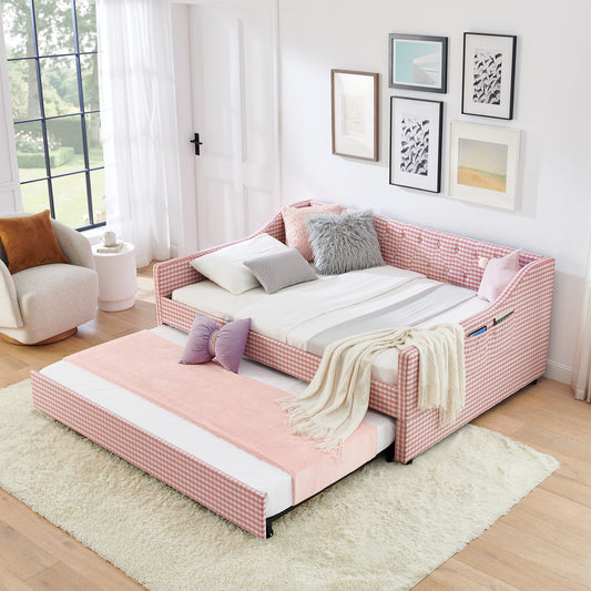 Full-size upholstered convertible daybed in pink with tufted button backrest, shown as a sofa