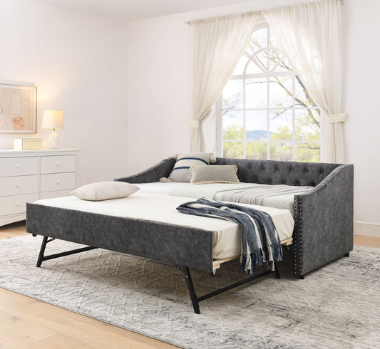 Twin size daybed with USB charging and pull-out trundle - front view showing button tufted backrest and copper nail trim on waved shape arms