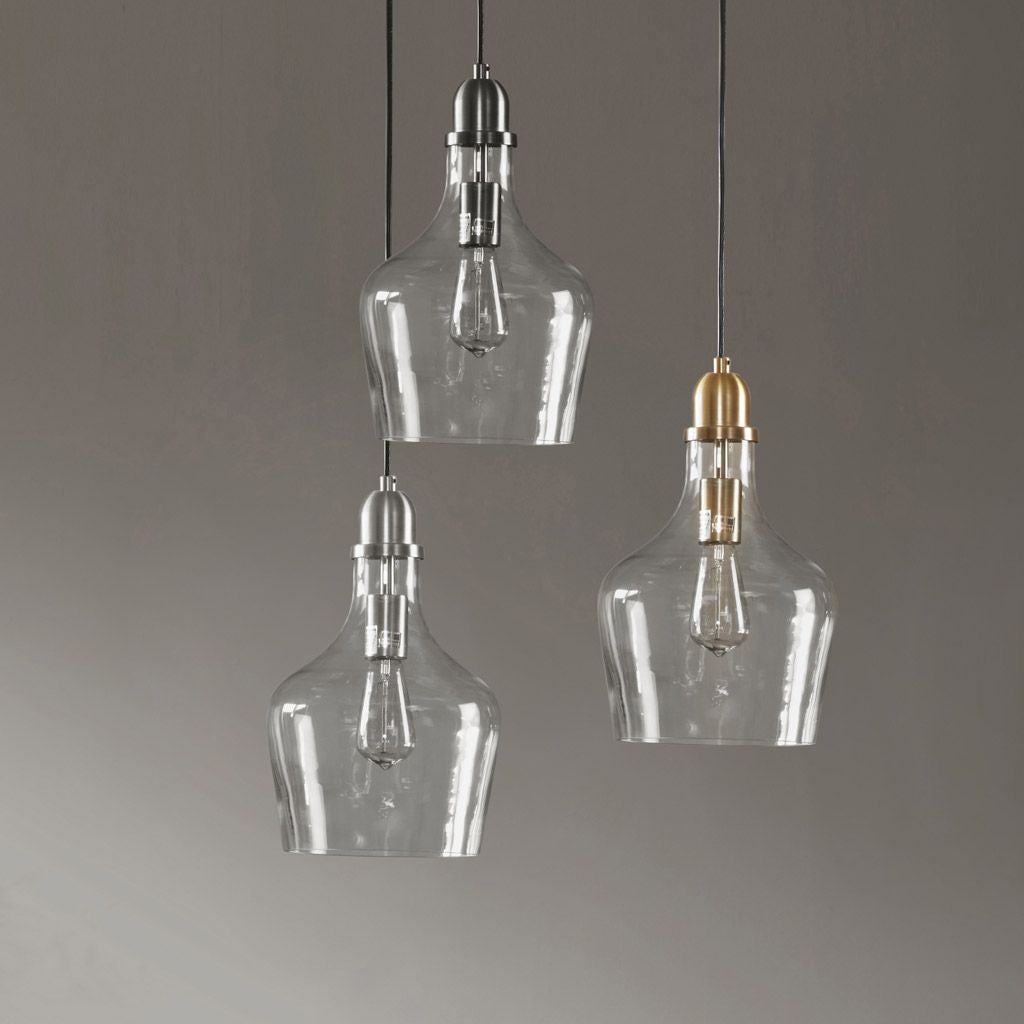 Gold clear glass pendant light hanging over dining table
