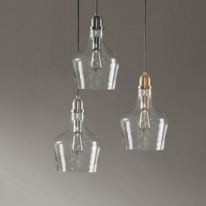 Gold clear glass pendant light hanging over dining table