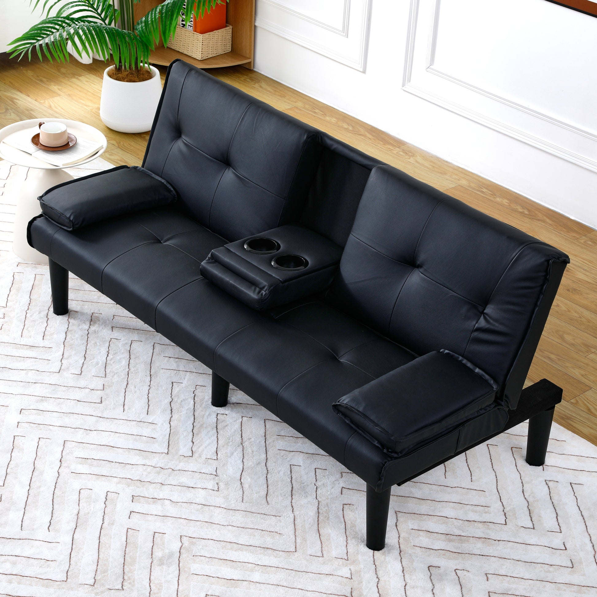 The 67-inch black PVC multi-functional sofa bed with a foldable and cup holder design makes it extremely convenient to turn the living room into a guest room image 1
