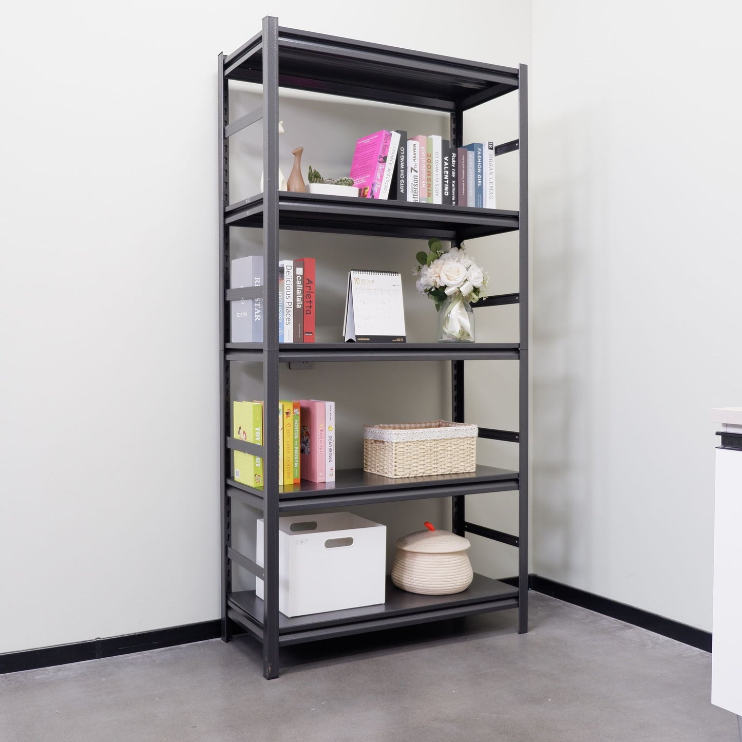 Metal shelving unit in office storing books and supplies