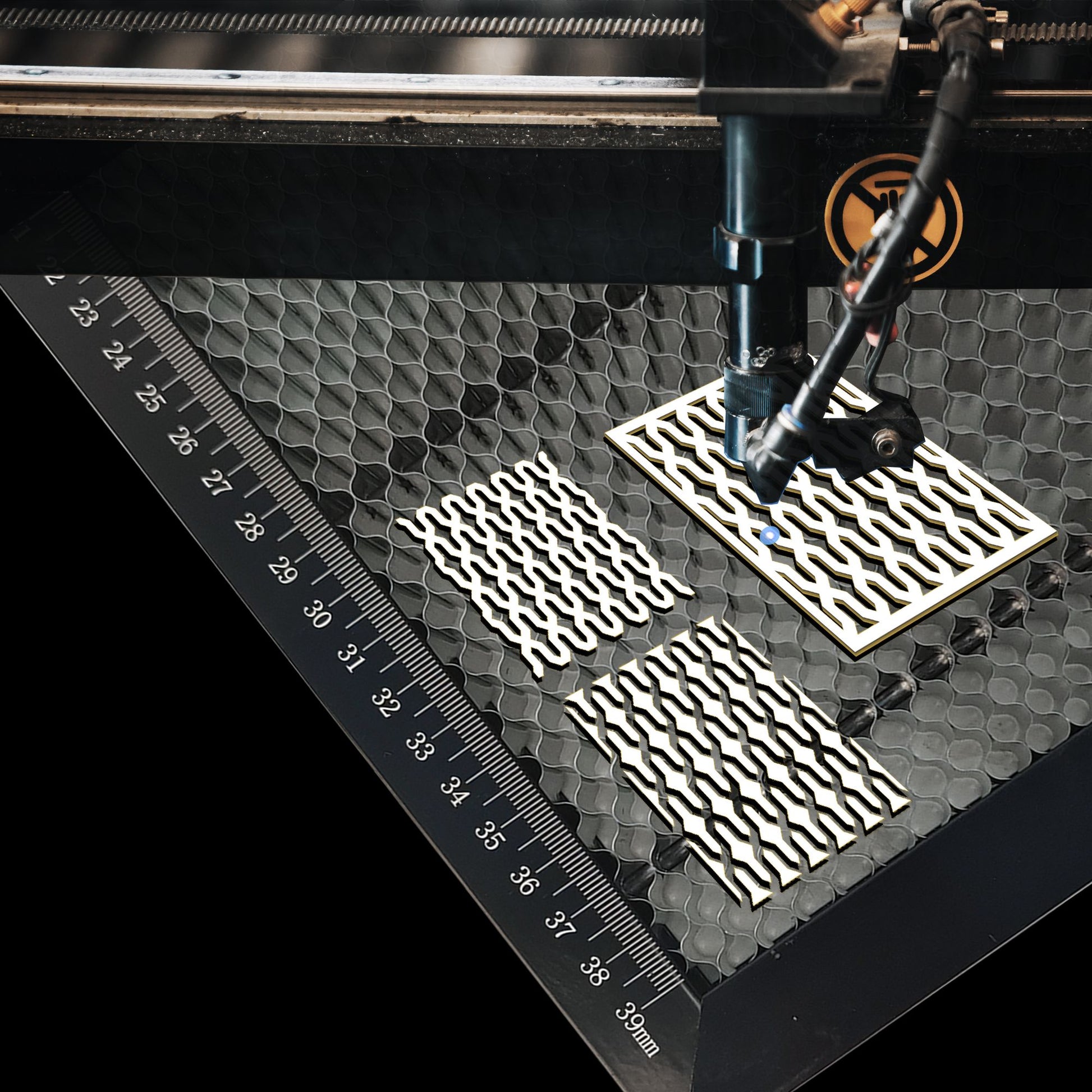 Close-up of honeycomb laser bed surface showing heat dissipation holes