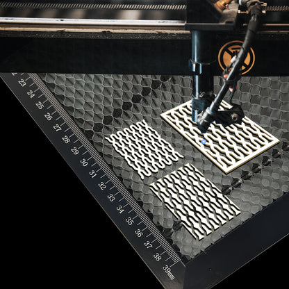 Close-up of honeycomb laser bed surface showing heat dissipation holes