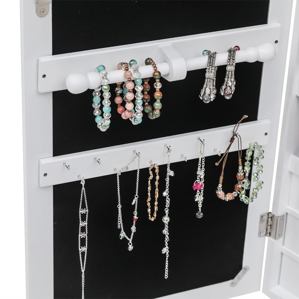 Interior of jewelry cabinet with ring grooves and hooks