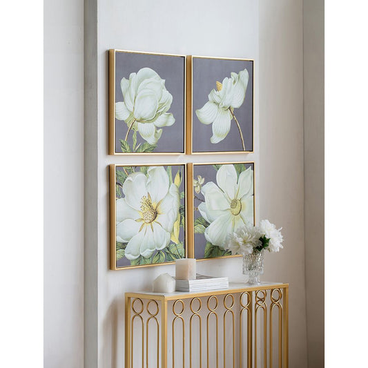Set of 4 white and gold botanical wall art prints on a white wall