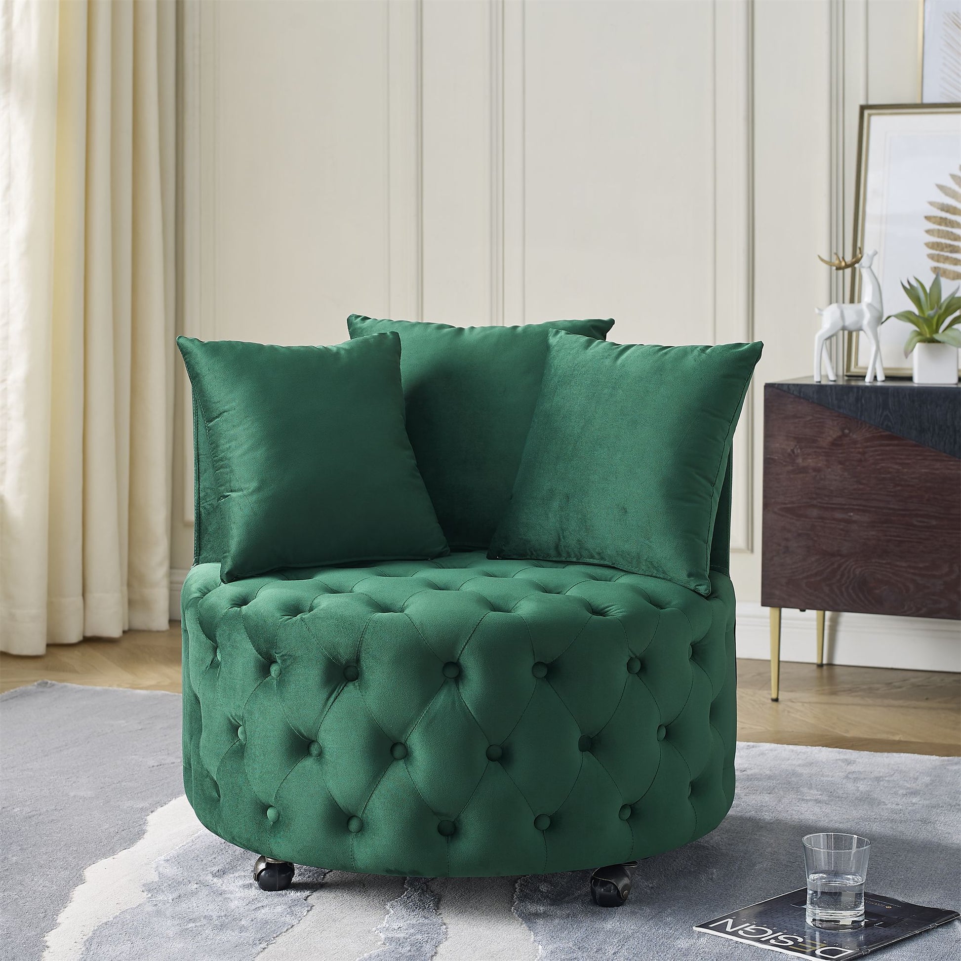 Velvet upholstered swivel chair in green with button tufted design and three pillows - front view